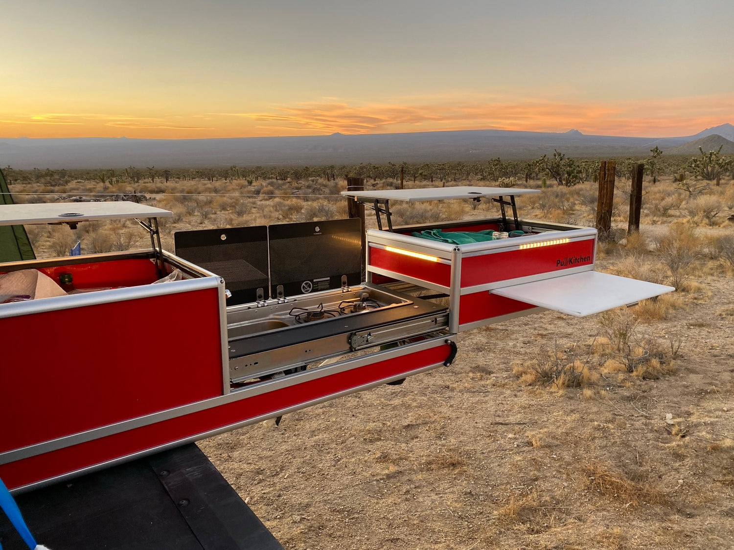 PullKitchen - Overland slide out camping truck kitchen mounted in a truck bed located in the Mojave desert preparing food during sunset